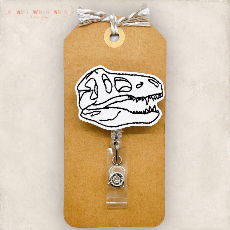 t rex skull badge reel