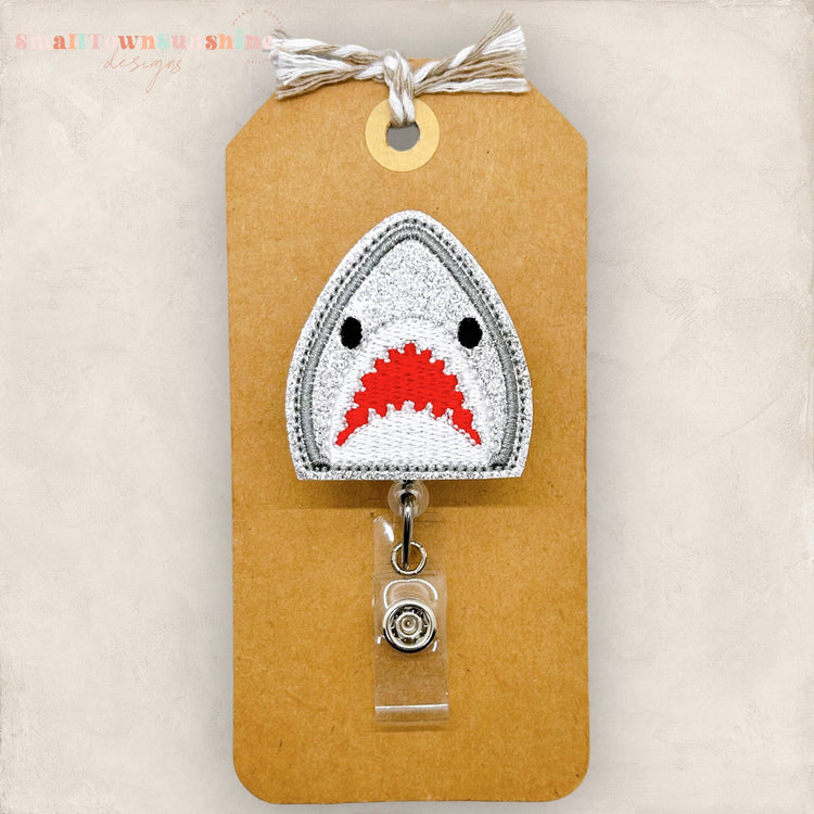 glitter grey embroidered shark badge reel