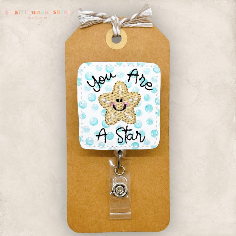 you are a star badge reel with an embroidered starfish