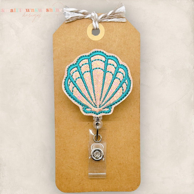 embroidered coral and teal shimmery badge reel