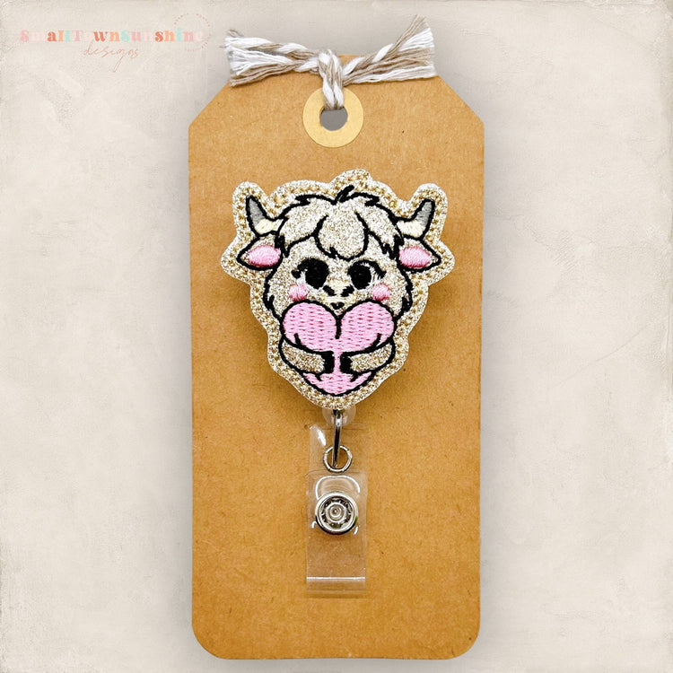highland cow hugging heart badge reel