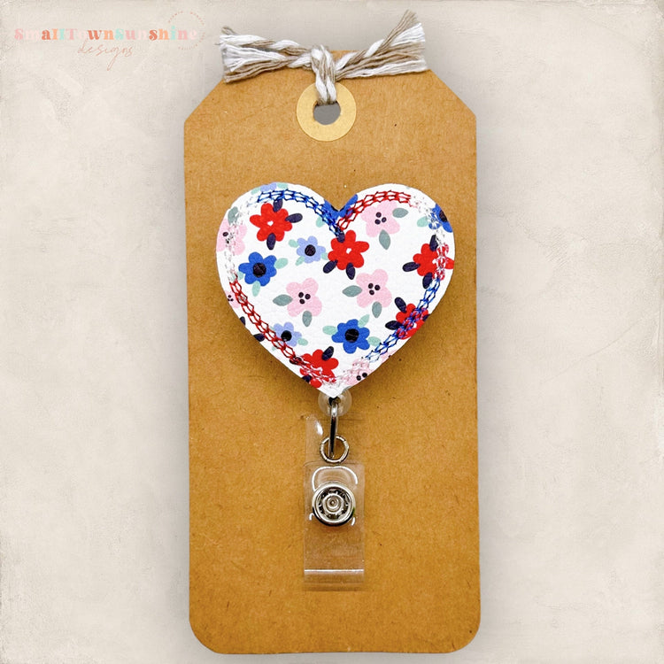 heart shaped badge reel with red white and blue flowers