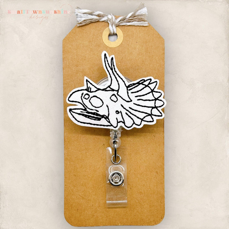 triceratops skull badge reel