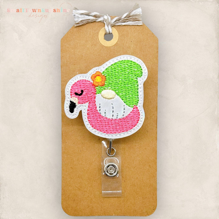 gnome in a flamingo pool float badge reel