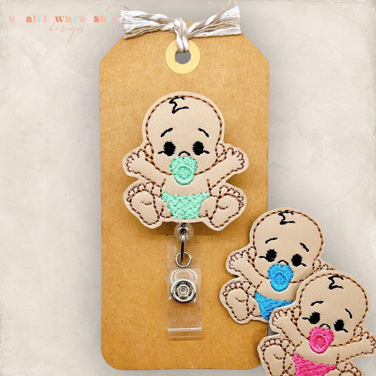 tan skinned baby badge reel