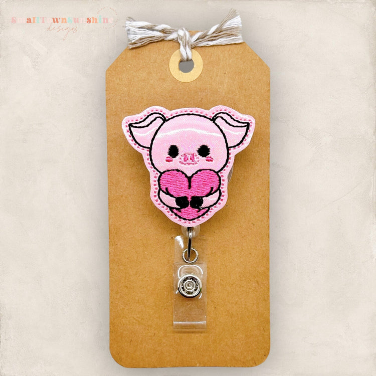 pig hugging heart embroidered badge reel