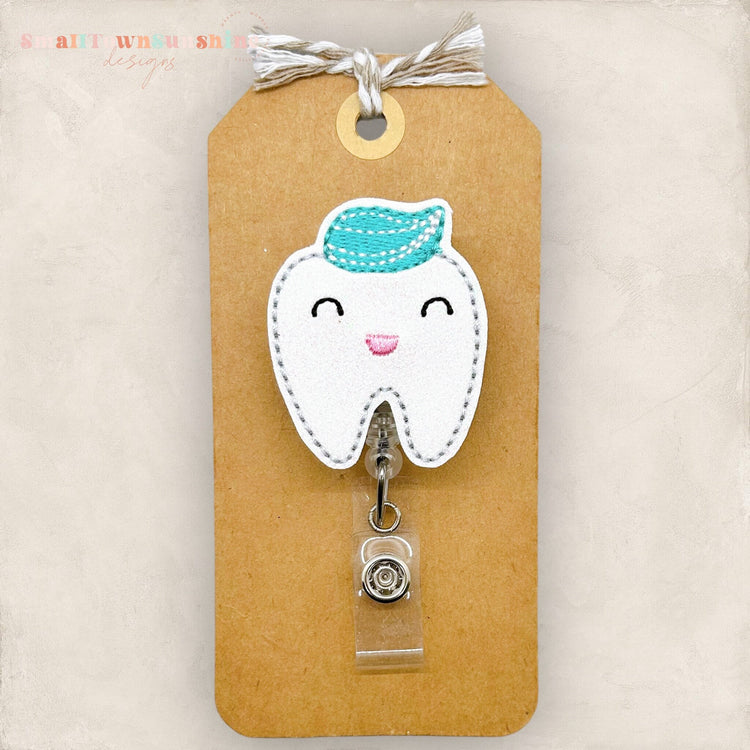 tooth with toothpaste on top badge reel
