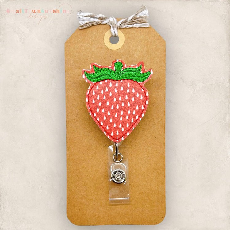 red strawberry with white seeds badge reel