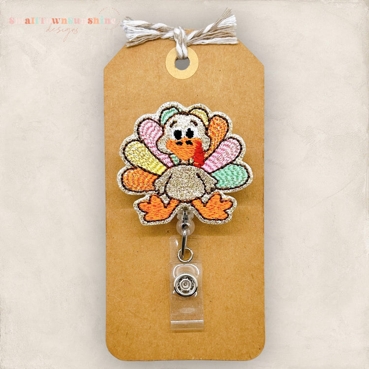 pastel feathered embroidered turkey badge reel
