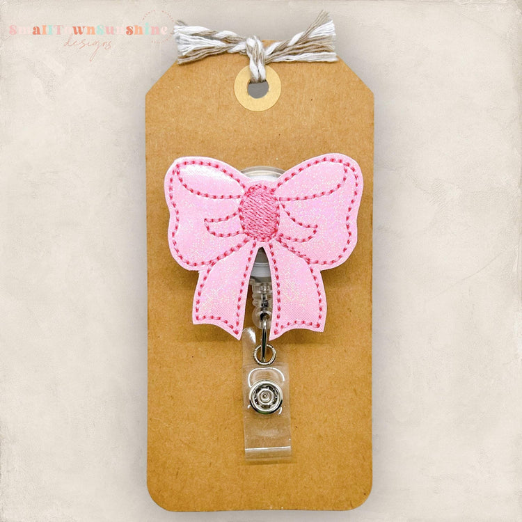 pretty pink bow badge reel