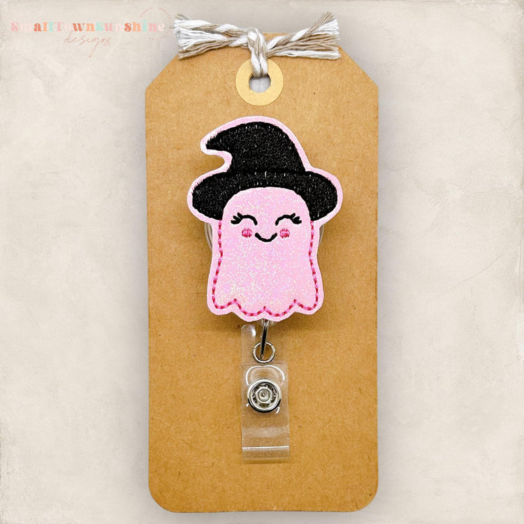pink ghost with a black witch hat badge reel