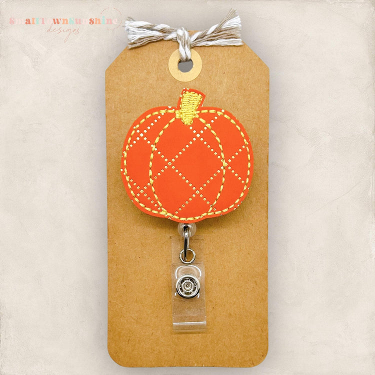 orange pumpkin with a gold diamond print, embroidered badge reel cover