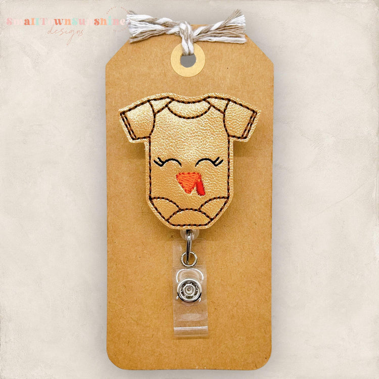 brown baby bodysuit with a turkey face embroidered for a badge reel