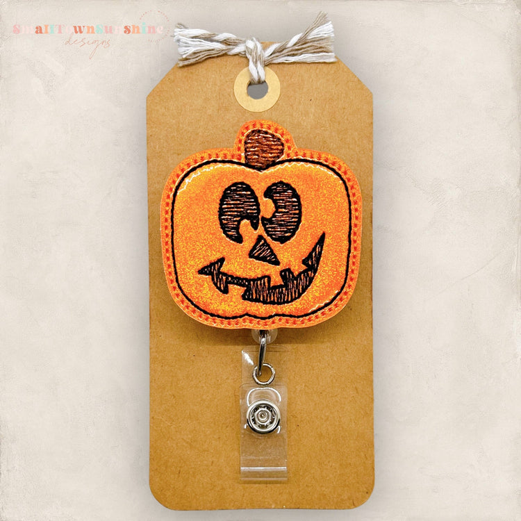 silly jack o lantern pumpkin face badge reel