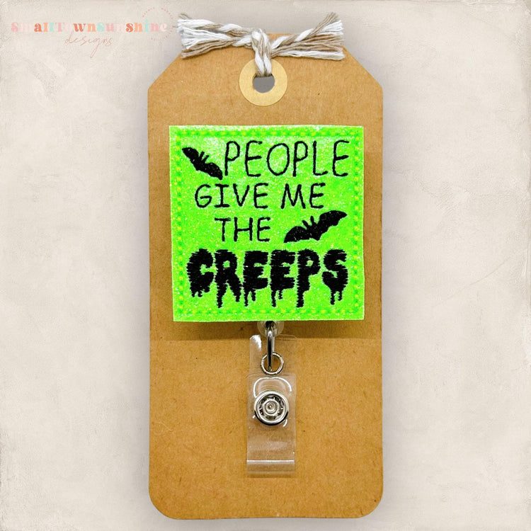 neon green glittery halloween badge reel, embroidered peoplegive me the creeps