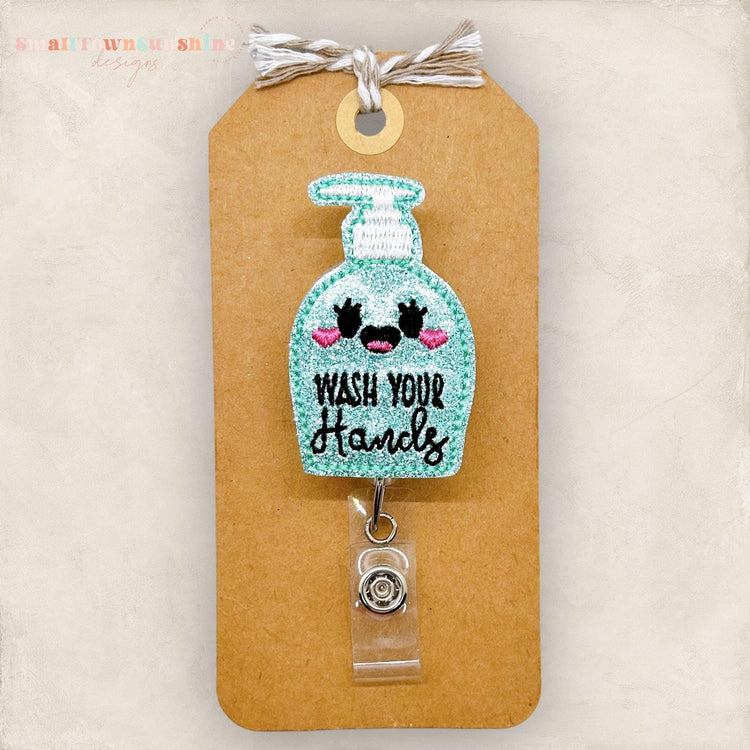 cute soap bottle with wash your hands embroidered on the front badge reel