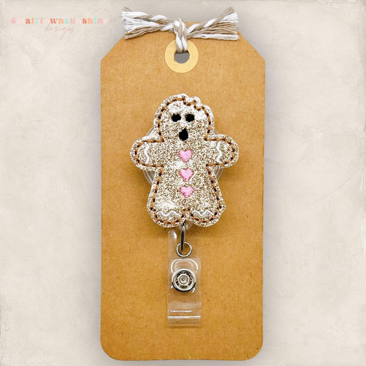 gingerbread cookie with bite out of the head badge reel