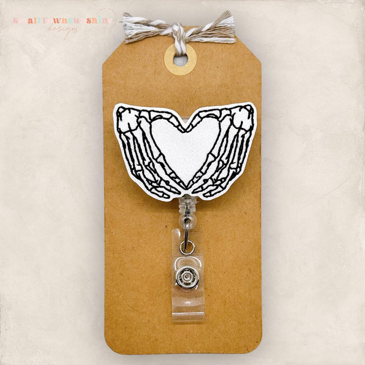 skeleton hands making a heart shape embroidered badge reel