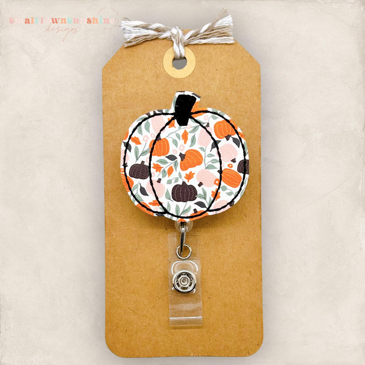 embroidered pumpkin with a pumpkin patch print, badge reel cover