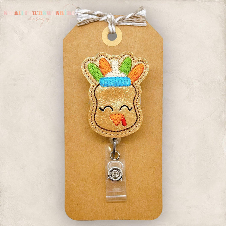 baby bottle with a turkey face and turkey tail feathers badge reel