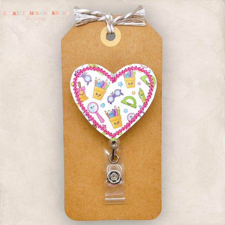 school supplies badge reel, pencil cup, ruler, school bell, magnifying glass, markers