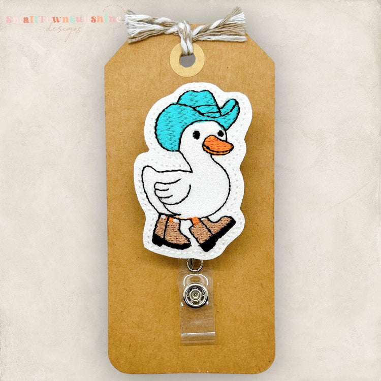 goose wearing turquoise cowboy hat badge reel topper