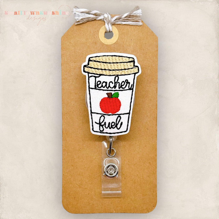 embroidered coffee cup with teacher fuel and an apple, badge reel cover