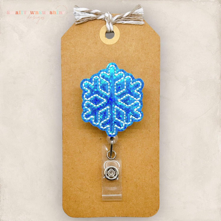 small blue holographic snowflake badge reel