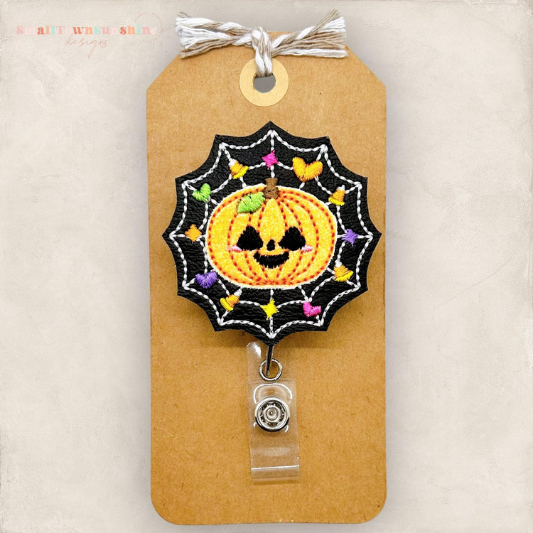 jackolantern in a spiderweb embroidered badge reel