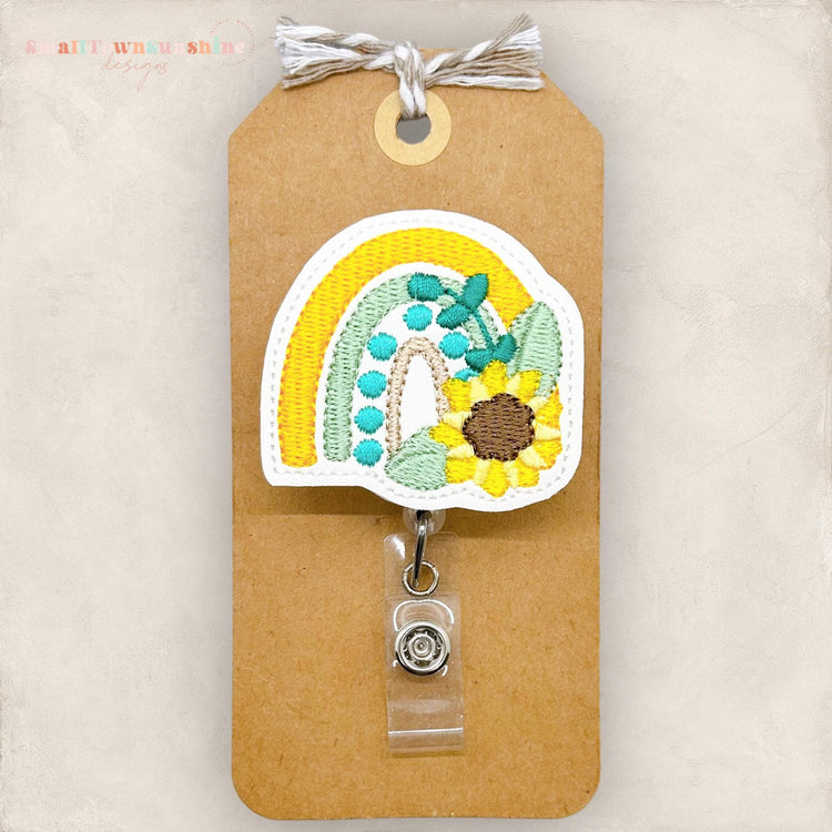 yellow and green rainbow with a sunflower badge reel