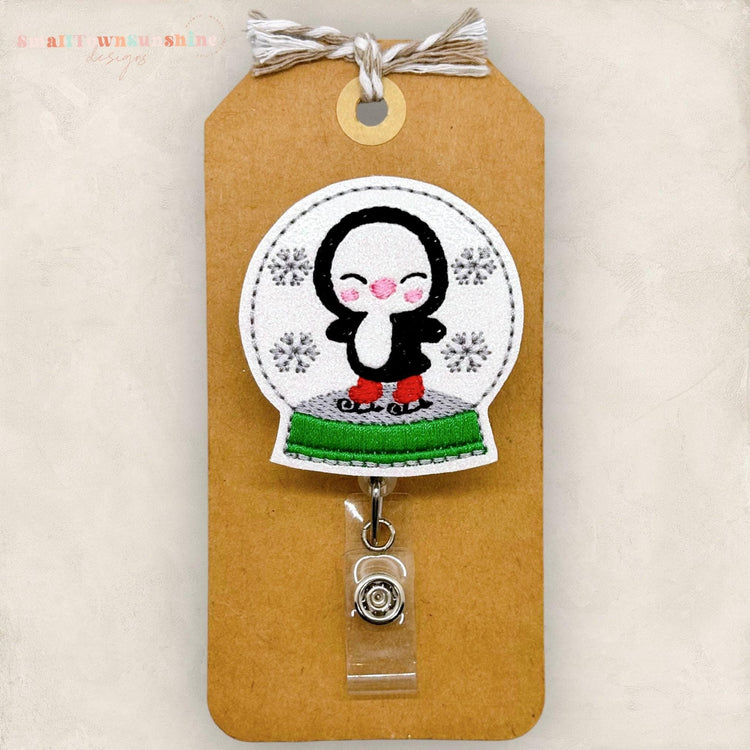 ice skating penguin inside snowy winter snow globe embroidered badge reel topper