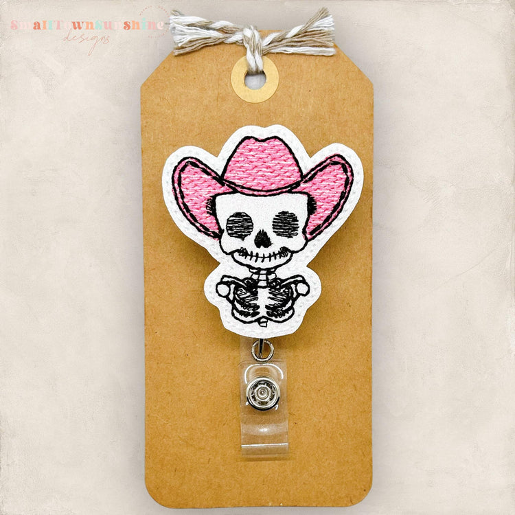 cute skeleton head with a pink cowboy hat embroidered badge reel cover