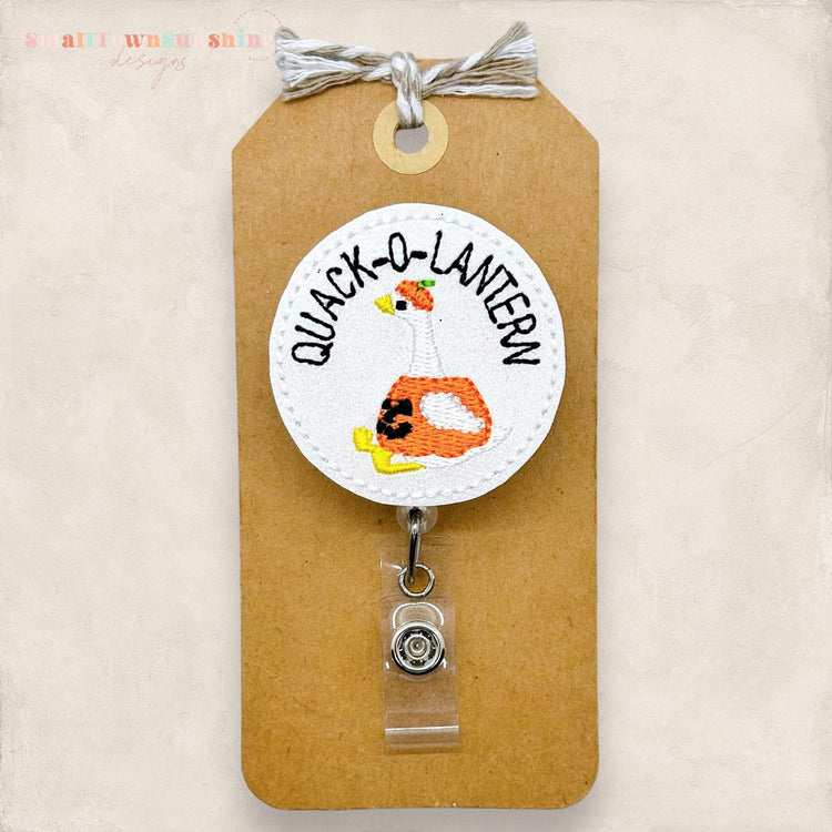 glittery white quack o lantern embroidered badge reel