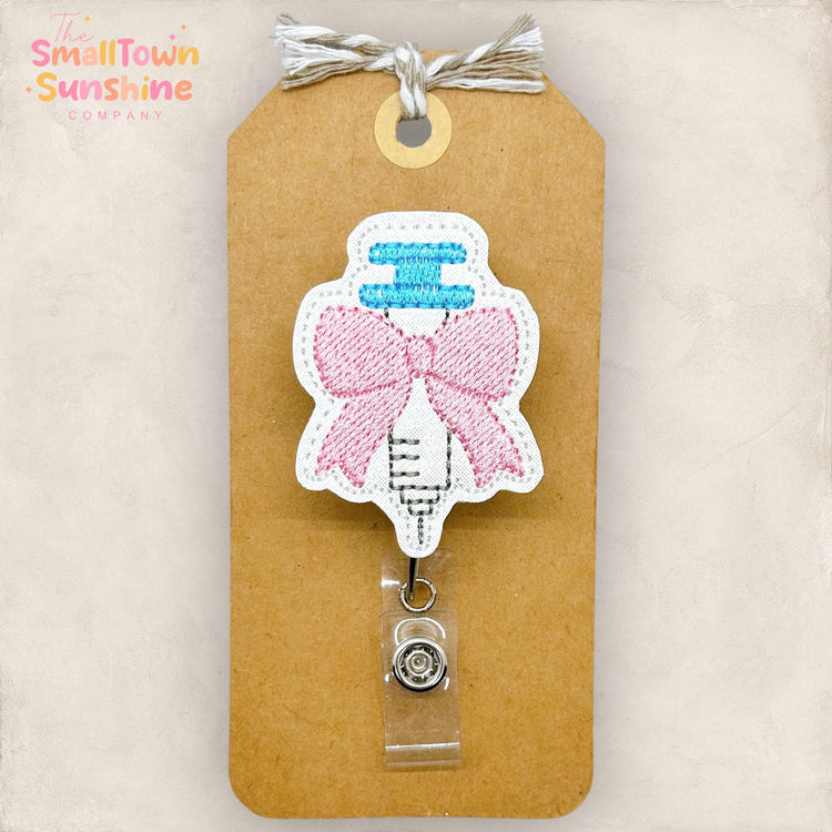 coquette pink bow syringe embroidered badge reel topper