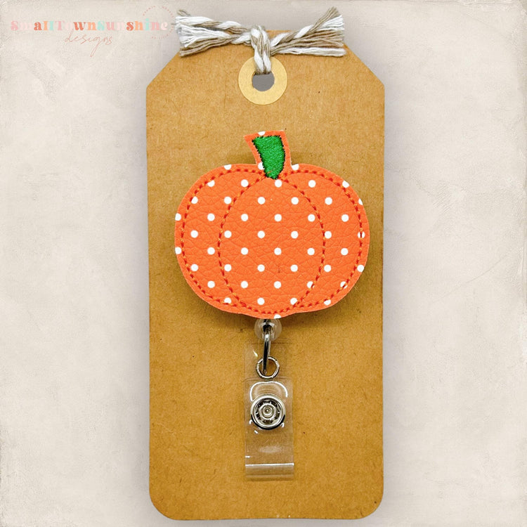 orange pumpkin with white polka dots embroidered badge reel topper