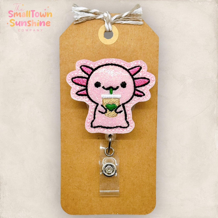 pink axolotl drinking iced coffee embroidered badge reel topper