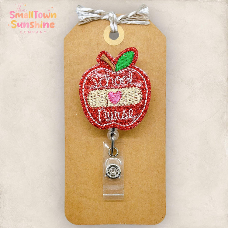 embroidered apple with school nurse and a bandage badge reel topper