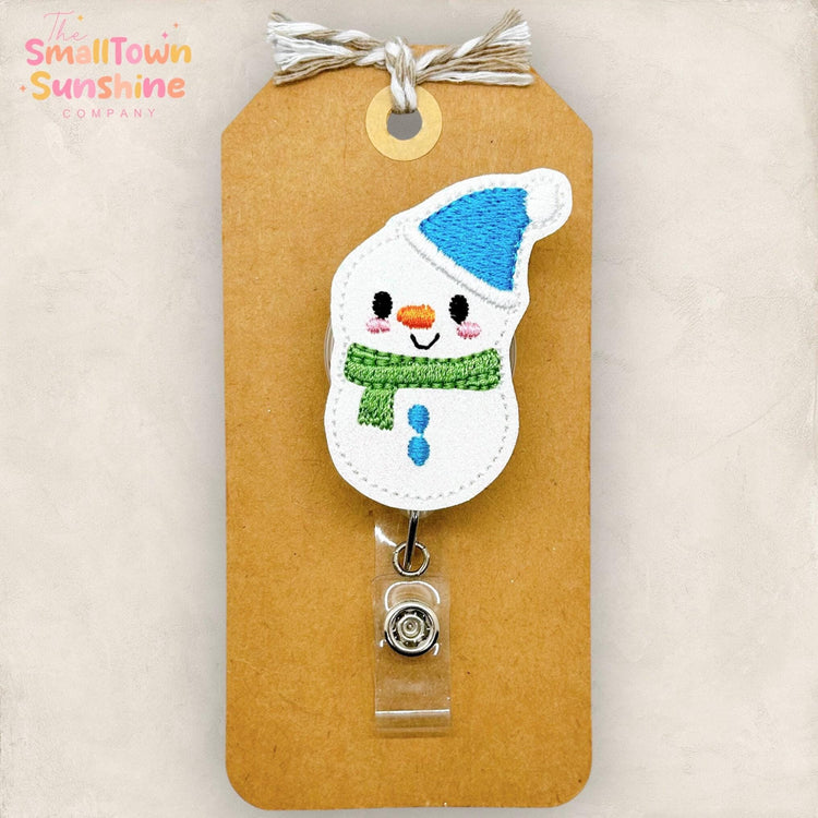 embroidered snowman with blue hat and green scarf badge reel topper