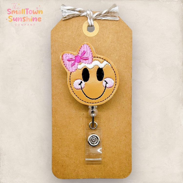 gingerbread girl face with pink bow badge reel topper