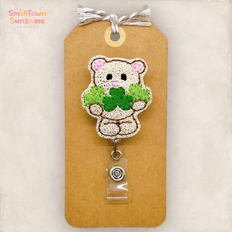 teddy bear holding clovers badge reel topper
