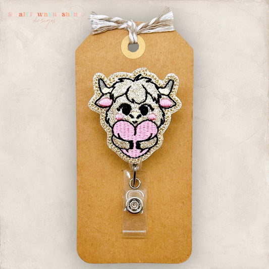 highland cow hugging heart badge reel