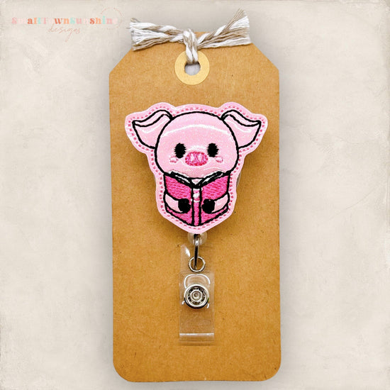 pig hugging book badge reel