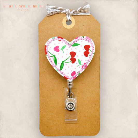 embroidered heart shaped badge reel cover with a cherry print