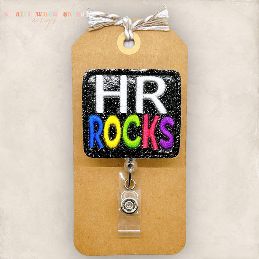 HR rocks badge reel, bright colored words stitched on black glitter vinyl