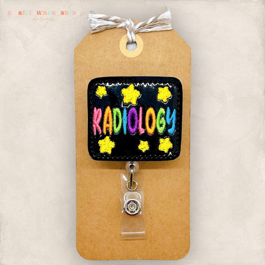 colorful radiology word with stars on black vinyl badge reel