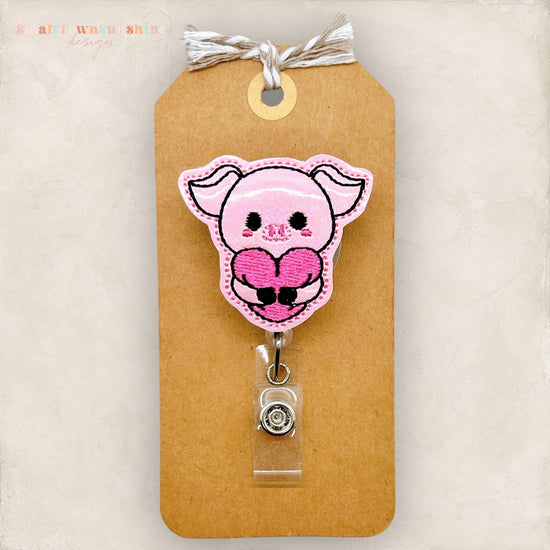 pig hugging heart embroidered badge reel