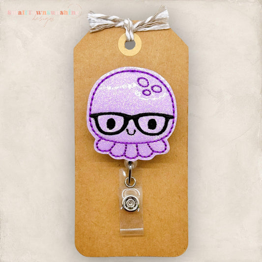 purple octopus with black glasses badge reel
