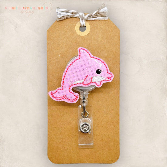 pink dolphin badge reel