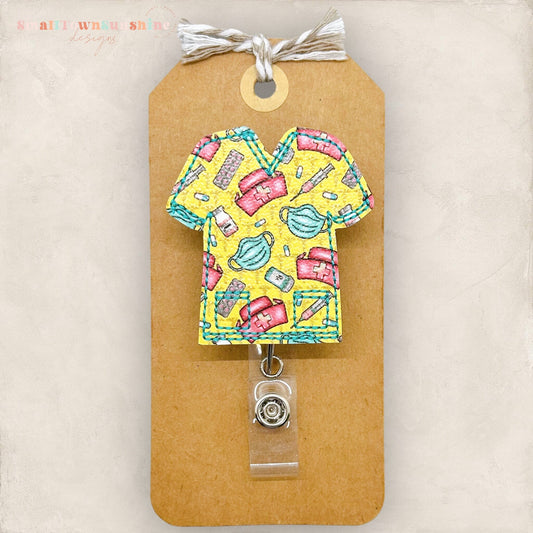 cute yellow scrub top with medical supplies badge reel