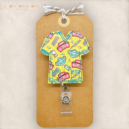 cute yellow scrub top with medical supplies badge reel